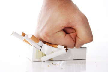 Man's hand crushing cigarettes