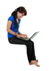 smiley woman with laptop sitting.