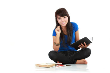 asian woman sit and writing a book