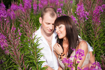 Romantic couple among purple flowers