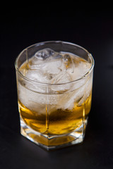 Glass of whisky on a black background