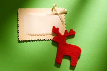 Greeting card and raindeer isolated on green background