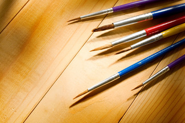 Paintbrushes isolated on wooden background