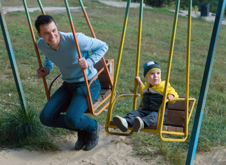Father and son on a swing
