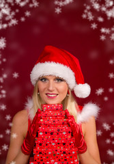 Beautiful blond girl in santa holding gifts