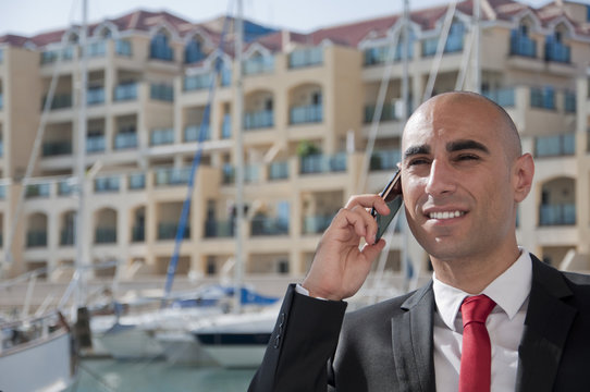 Business Man on the phone at the Marina