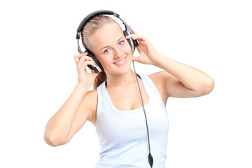 Naklejka premium A happy young woman listening music