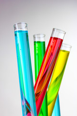 Test-tubes with liquid on gray background