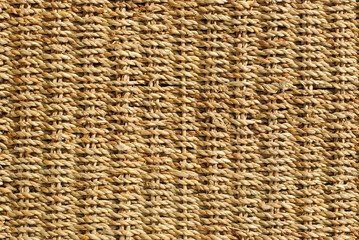 wicker basket with original pattern, straw background