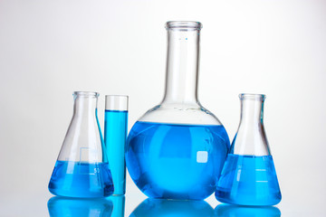 Test-tubes with blue liquid isolated on white