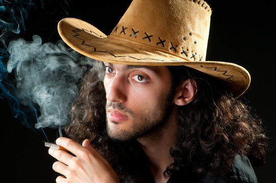 Man in cowbow hat smoking