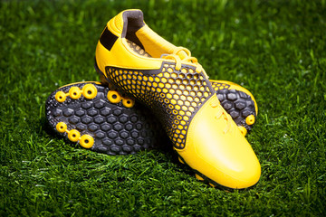 Pair of soccer shoes on grass field