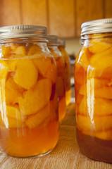 Glass jars of home canned peaches