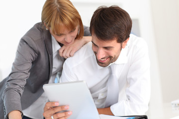 Business people in office using electronic tablet