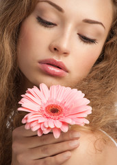 Beautiful woman with flower in her hand