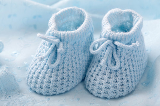 Blue baby booties on blue background