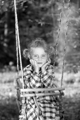 Beauty little girl on a swing