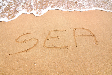 Sea you text written on the beach sand