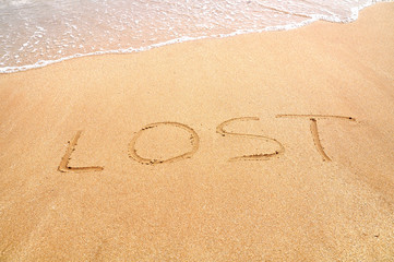 Lost text written on the beach sand