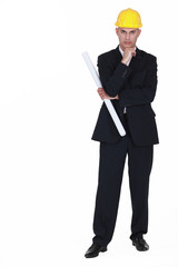 Serious architect standing with plans