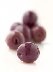 Olives in brine on white background.