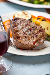 Grilled beefsteak with pan cooked vegetables and wine