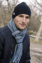 portrait of young man in black cap and striped