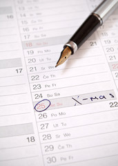 A date circled on a calendar with fountain pen
