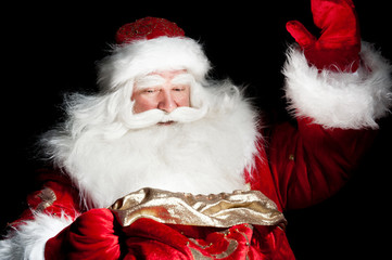 Santa sitting at the Christmas room and looking into the sack