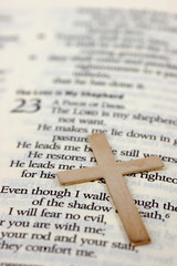 Gold cross on bible with selective focus