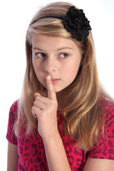 Naklejka premium Keep quiet by scared young school girl alone