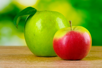 Two ripe apples on table outdoors