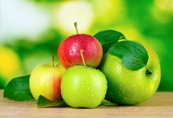 Fresh organic apples on wooden table isolated on white