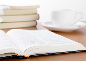 Cup book and plant on wooden table