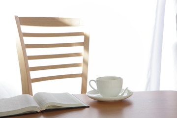 coffee Cup book and plant on wooden table