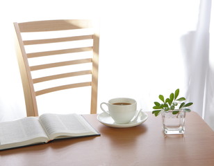 coffee Cup book and plant on wooden table