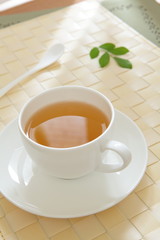 green tea with morning sunlight from window and green leaf