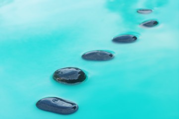 Fototapeta na wymiar six stones in water
