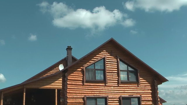Time lapse shot of log house against sky.