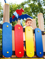 Child on slide outdoor in park.