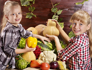 Fototapeta premium Child with vegetable on kitchen.