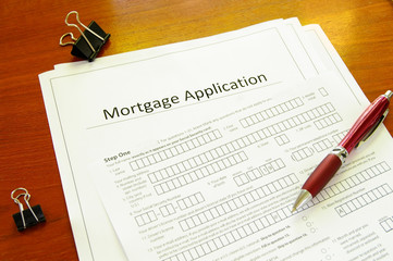 Blank mortgage application with pen and clips