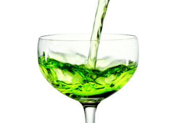 green martini cocktail into glass on white background