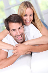 Young couple laying down sofa