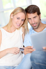 Young couple at home doing online shopping