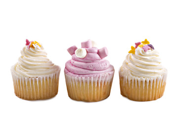 Pink and cream cupcakes against a white background