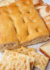 Closeup of genoese focaccia, bread and crackers.