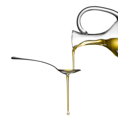 Pouring oil on spoon isolated on white