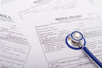 A prescription form and stethoscope on a doctor's desk