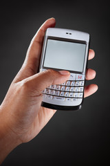 Hand holding qwerty handphone